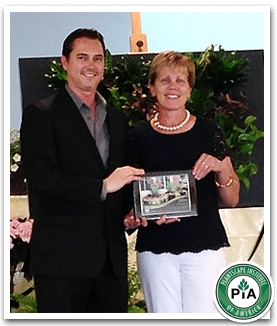 Eli Bennett of Plantscape Institute of America presents Lynn Ott with The Gold Award for “ Four Seasons of Interest" for one of our Exterior Installations in Clayton. 